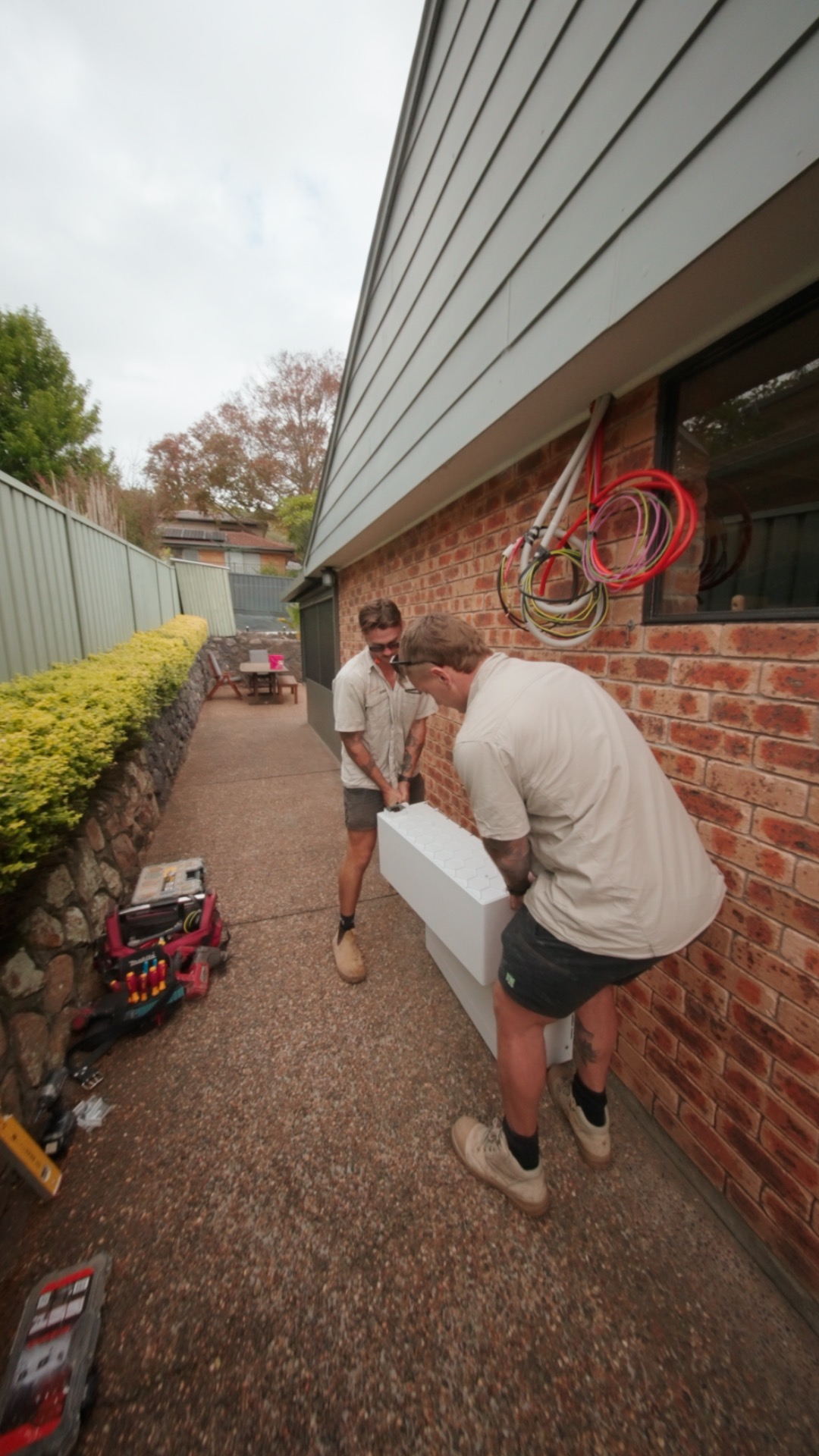 Elite Energy installers fitting a home battery system
