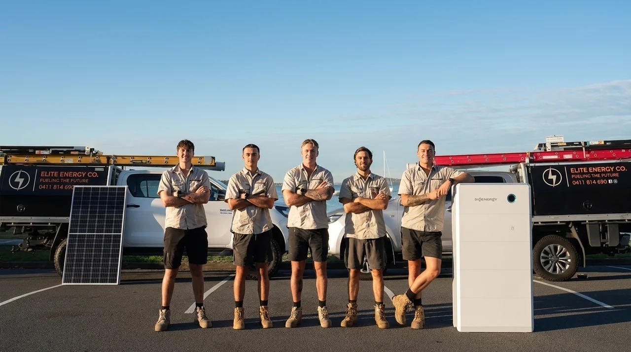 The Elite Energy Co. team with their service vehicles