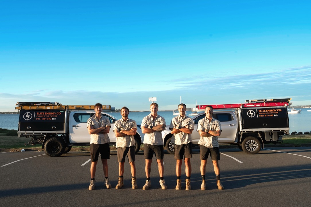 The Elite Energy Co. team with their branded service vehicles